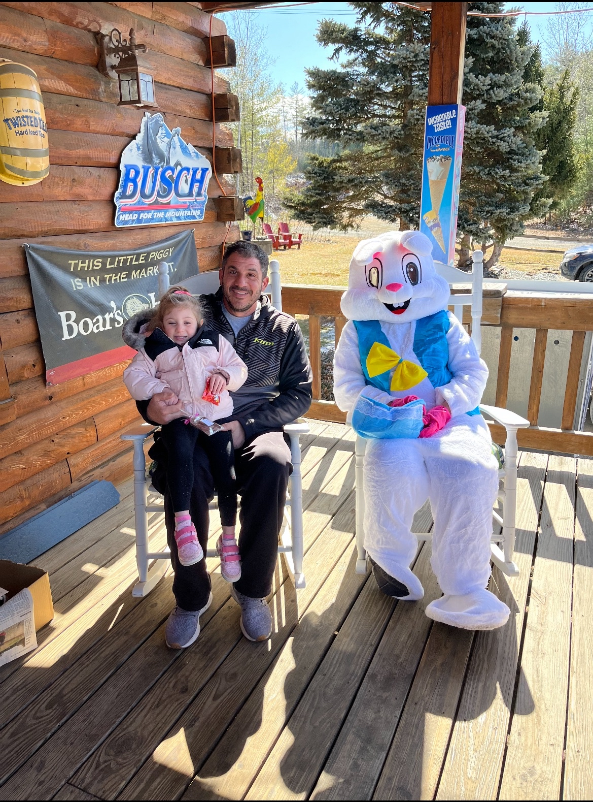 Dad and daughter with the Easter Bunny on the porch at Swiftwater Way Station